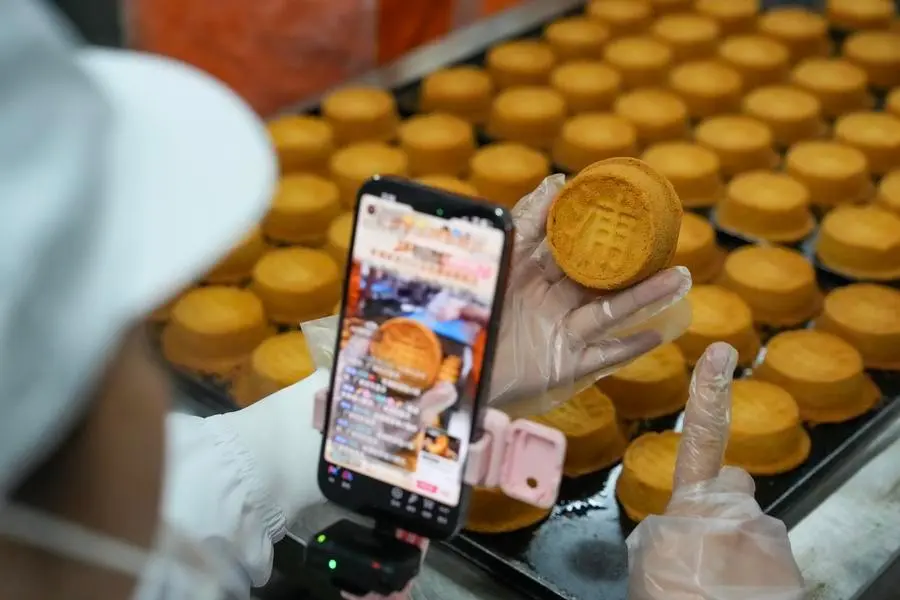 Uma funcionária promove bolos lunares de presunto via transmissão ao vivo em uma empresa de alimentos na cidade de Xuanwei, província de Yunnan, no sudoeste da China, em 3 de setembro de 2026. (Xinhua/Chen Xinbo) Uma funcionária promove bolos lunares de presunto via transmissão ao vivo em uma empresa de alimentos na cidade de Xuanwei, província de Yunnan, no sudoeste da China, em 3 de setembro de 2026. (Xinhua/Chen Xinbo)